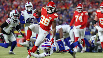 Jan 26, 2025; Kansas City, MO, USA; Kansas City Chiefs running back Kareem Hunt (29) breaks a tackle against Buffalo Bills safety Cole Bishop (24) during the first quarter in the AFC Championship game at GEHA Field at Arrowhead Stadium. Mandatory Credit: Mark J. Rebilas-Imagn Images