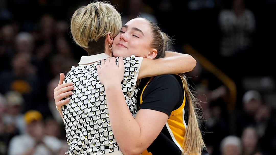 Iowa forward AJ Ediger (34) hugs Iowa head coach Jan Jensen during senior recognition after playing Wisconsin Sunday, March 2, 2025 at Carver-Hawkeye Arena in Iowa City, Iowa.