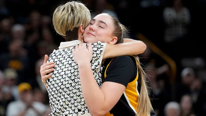 Iowa forward AJ Ediger (34) hugs Iowa head coach Jan Jensen during senior recognition after playing Wisconsin Sunday, March 2, 2025 at Carver-Hawkeye Arena in Iowa City, Iowa.