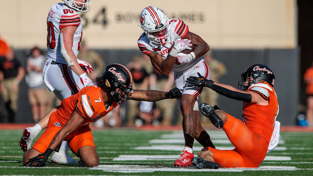 Sep 21, 2024; Stillwater, Oklahoma, USA; Utah Utes wide receiver Dorian Singer (3) tries to break a tackle during the third quarter against the Oklahoma State Cowboys at Boone Pickens Stadium. Mandatory Credit: William Purnell-Imagn Images
