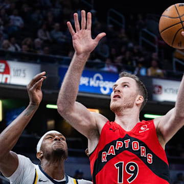 Feb 26, 2025; Indianapolis, Indiana, USA; Toronto Raptors center Jakob Poeltl (19) shoots the ball while Indiana Pacers center Myles Turner (33) defends in the first half at Gainbridge Fieldhouse. Mandatory Credit: Trevor Ruszkowski-Imagn Images
