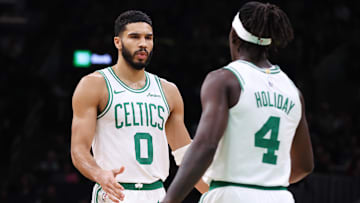 Boston Celtics forward Jayson Tatum (0) celebrates with Boston Celtics guard Jrue Holiday (4) during the first half against the Memphis Grizzlies at TD Garden.