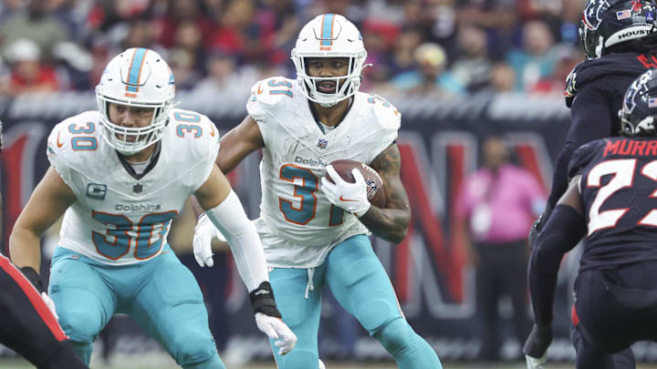 Dec 15, 2024; Houston, Texas, USA; Miami Dolphins running back Raheem Mostert (31) runs with the ball during the game against the Houston Texans at NRG Stadium. Mandatory Credit: Troy Taormina-Imagn Images
