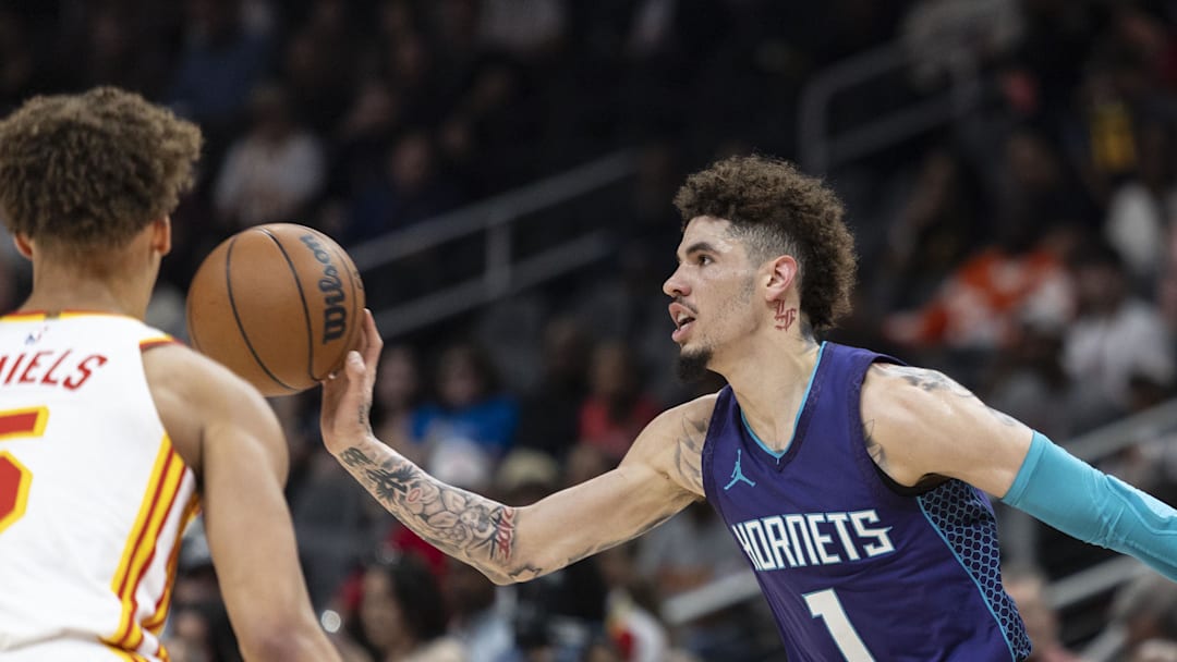 Oct 25, 2024; Atlanta, Georgia, USA; Charlotte Hornets guard LaMelo Ball (1) passes the ball past Atlanta Hawks guard Dyson Daniels (5) during the first quarter at State Farm Arena. Mandatory Credit: Jordan Godfree-Imagn Images
