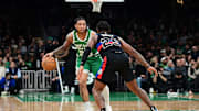 Dec 12, 2024; Boston, Massachusetts, USA; Boston Celtics guard JD Davison (20) dribbles against Detroit Pistons guard Marcus Sasser (25) during the second half at TD Garden. Mandatory Credit: Eric Canha-Imagn Images
