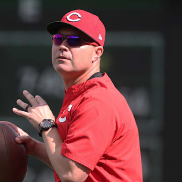 May 19, 2025; Pittsburgh, Pennsylvania, USA;  Cincinnati Reds third base coach J.R. House (56) throws a football on the field before the game against the Pittsburgh Pirates at PNC Park. Mandatory Credit: Charles LeClaire-Imagn Images