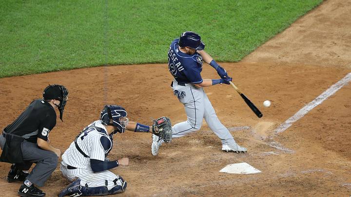 Aug 19, 2020; Bronx, New York, USA; Tampa Bay Rays pinch hitter Mike Brosseau (43) hits an RBI single against the New York Yankees during the eighth inning at Yankee Stadium. Mandatory Credit: Brad Penner-Imagn Images