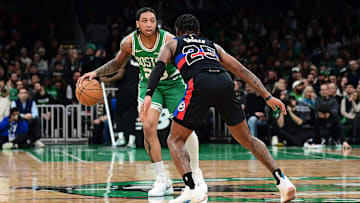 Dec 12, 2024; Boston, Massachusetts, USA; Boston Celtics guard JD Davison (20) dribbles against Detroit Pistons guard Marcus Sasser (25) during the second half at TD Garden.