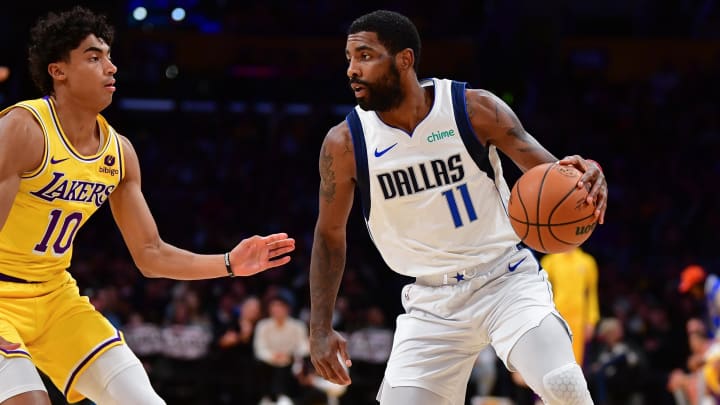 Nov 22, 2023; Los Angeles, California, USA; Dallas Mavericks guard Kyrie Irving (11) moves the ball against Los Angeles Lakers guard Max Christie (10) during the first half at Crypto.com Arena. Mandatory Credit: Gary A. Vasquez-USA TODAY Sports