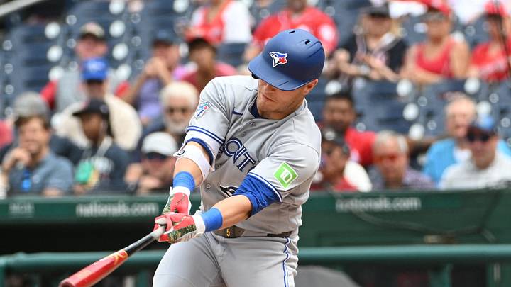 Jul 29, 2026; Washington, District of Columbia, USA; Toronto Blue Jays center fielder Daulton Varsho (5) hits a RBI infield single against the Washington Nationals during the seventh inning at Nationals Park. Mandatory Credit: Brad Mills-Imagn Images