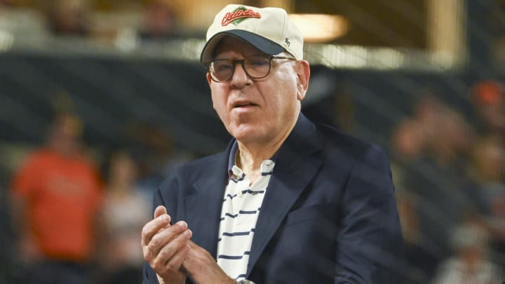 Jun 28, 2024; Baltimore, Maryland, USA;  Baltimore Orioles owner David Rubenstein  stands with Bird on top of the dugout during the seventh inning stretch against the Texas Rangers at Oriole Park at Camden Yards