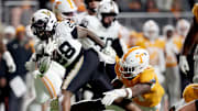Vanderbilt running back Sedrick Alexander (28) runs past Tennessee linebacker Edwin Spillman (13) during the third quarter at Neyland Stadium in Knoxville, Tenn., Saturday, Nov. 29, 2025.