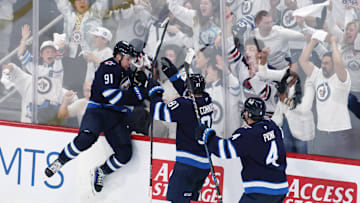 May 4, 2025; Winnipeg, Manitoba, CAN; Winnipeg Jets center Cole Perfetti (91) celebrates after his goal against the St. Louis Blues with teammates left wing Kyle Connor (81) and defenseman Neal Pionk (4) in the third period in game seven of the first round of the 2025 Stanley Cup Playoffs at Canada Life Centre. Mandatory Credit: James Carey Lauder-Imagn Images