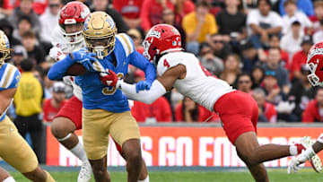Nov 30, 2024; Pasadena, California, USA; UCLA Bruins wide receiver Kwazi Gilmer (3) tries to break free from Fresno State Bulldogs linebacker RL Miller (4) during the third quarter at Rose Bowl. Mandatory Credit: Robert Hanashiro-Imagn Images