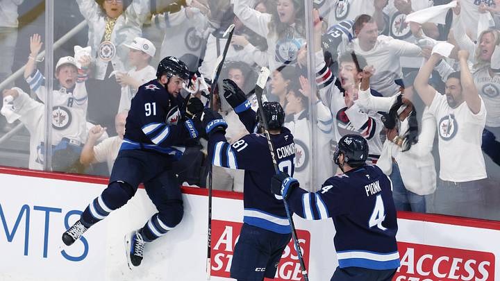May 4, 2025; Winnipeg, Manitoba, CAN; Winnipeg Jets center Cole Perfetti (91) celebrates after his goal against the St. Louis Blues with teammates left wing Kyle Connor (81) and defenseman Neal Pionk (4) in the third period in game seven of the first round of the 2025 Stanley Cup Playoffs at Canada Life Centre. Mandatory Credit: James Carey Lauder-Imagn Images