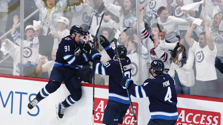 May 4, 2025; Winnipeg, Manitoba, CAN; Winnipeg Jets center Cole Perfetti (91) celebrates after his goal against the St. Louis Blues with teammates left wing Kyle Connor (81) and defenseman Neal Pionk (4) in the third period in game seven of the first round of the 2025 Stanley Cup Playoffs at Canada Life Centre. Mandatory Credit: James Carey Lauder-Imagn Images
