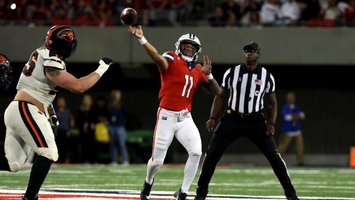 Oct 28, 2023; Tucson, Arizona, USA; Arizona Wildcats quarterback Noah Fifita #11 makes a pass down the field agaisnt Oregon State Beavers defensive lineman Joe Golden #95 during the first half at Arizona Stadium.