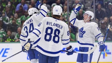 Apr 7, 2022; Dallas, Texas, USA; Toronto Maple Leafs center Auston Matthews (34) and right wing William Nylander (88) and right wing Mitchell Marner (16) celebrate after center Auston Matthews (34) scores a power goal against the Dallas Stars during the second period at the American Airlines Center and set the Leafs  team record for most goals in a season. Mandatory Credit: Jerome Miron-Imagn Images