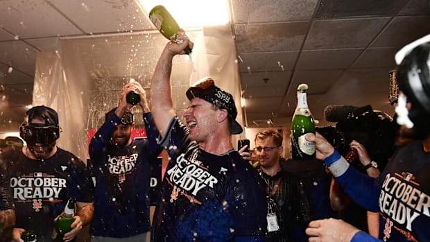 New York Mets first baseman Pete Alonso celebrates with teammates in the clubhouse after defeating the Milwaukee Brewers.
