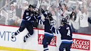 May 4, 2025; Winnipeg, Manitoba, CAN; Winnipeg Jets center Cole Perfetti (91) celebrates after his goal against the St. Louis Blues with teammates left wing Kyle Connor (81) and defenseman Neal Pionk (4) in the third period in game seven of the first round of the 2025 Stanley Cup Playoffs at Canada Life Centre. Mandatory Credit: James Carey Lauder-Imagn Images