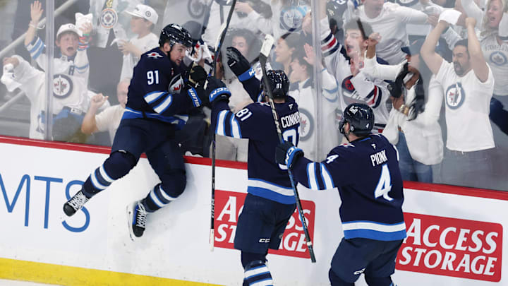 May 4, 2025; Winnipeg, Manitoba, CAN; Winnipeg Jets center Cole Perfetti (91) celebrates after his goal against the St. Louis Blues with teammates left wing Kyle Connor (81) and defenseman Neal Pionk (4) in the third period in game seven of the first round of the 2025 Stanley Cup Playoffs at Canada Life Centre. Mandatory Credit: James Carey Lauder-Imagn Images