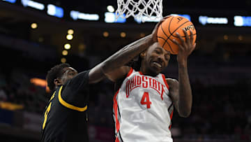 Mar 12, 2025; Indianapolis, IN, USA; Ohio State Buckeyes forward Aaron Bradshaw (4) rebounds the ball against Iowa Hawkeyes forward Seydou Traore (7) during the second half at Gainbridge Fieldhouse. Mandatory Credit: Robert Goddin-Imagn Images