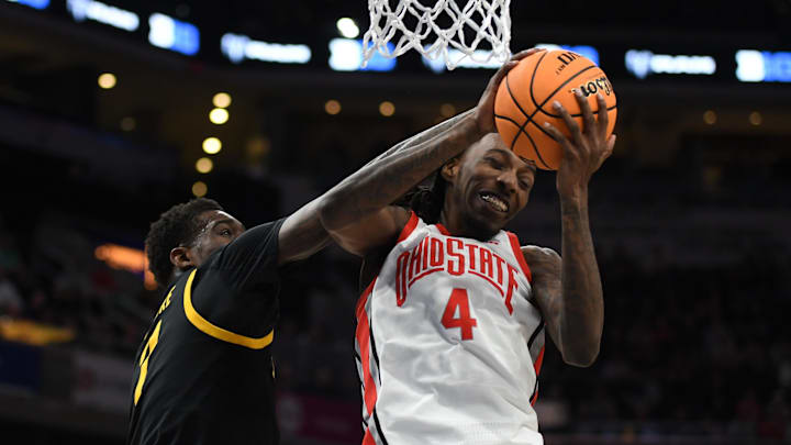Mar 12, 2025; Indianapolis, IN, USA; Ohio State Buckeyes forward Aaron Bradshaw (4) rebounds the ball against Iowa Hawkeyes forward Seydou Traore (7) during the second half at Gainbridge Fieldhouse. Mandatory Credit: Robert Goddin-Imagn Images