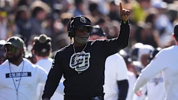 Nov 16, 2024; Boulder, Colorado, USA; Colorado Buffaloes head coach Deion Sanders calls in a play in the first quarter against the Utah Utes at Folsom Field. Mandatory Credit: Ron Chenoy-Imagn Images