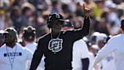Nov 16, 2024; Boulder, Colorado, USA; Colorado Buffaloes head coach Deion Sanders calls in a play in the first quarter against the Utah Utes at Folsom Field. 