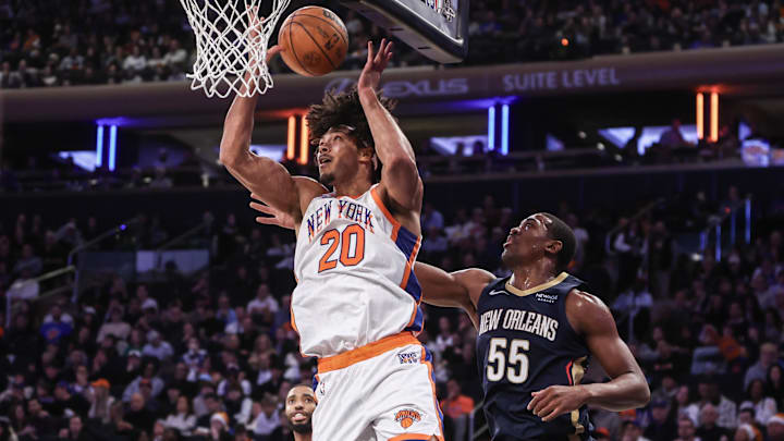 Dec 1, 2024; New York, New York, USA;  New York Knicks center Jericho Sims (20) gets the rebound in front of New Orleans Pelicans center Trey Jemison III (55) in the fourth quarter at Madison Square Garden. Mandatory Credit: Wendell Cruz-Imagn Images