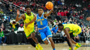 Mar 14, 2024; Las Vegas, NV, USA; UCLA Bruins guard Dylan Andrews (2) dribbles ahead of Oregon Ducks guard Jermaine Couisnard (5) during the second half at T-Mobile Arena. Mandatory Credit: Stephen R. Sylvanie-USA TODAY Sports