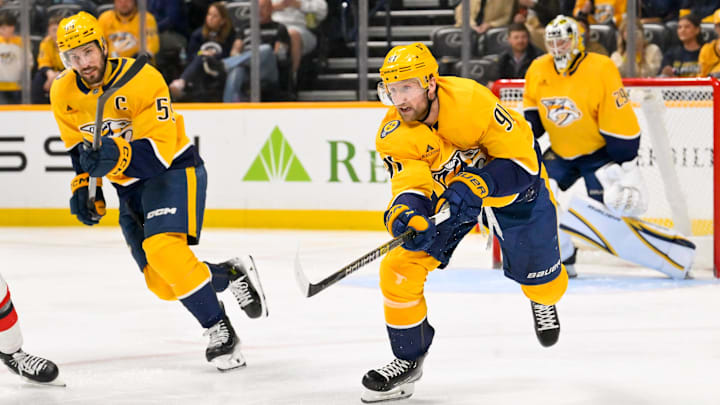Mar 26, 2026; Nashville, Tennessee, USA;  Nashville Predators center Steven Stamkos (91) clears the puck against the New Jersey Devils during the second period at Bridgestone Arena. Mandatory Credit: Steve Roberts-Imagn Images