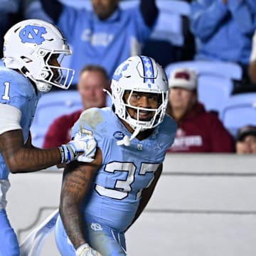Nov 8, 2025; Chapel Hill, North Carolina, USA; North Carolina Tar Heels running back Davion Gause (37) celebrates with wide receiver Jordan Shipp (1) after scoring a touchdown in the third quarter at Kenan Stadium. Mandatory Credit: Bob Donnan-Imagn Images
