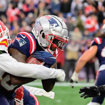 Dec 17, 2023; Foxborough, Massachusetts, USA; Kansas City Chiefs safety Chamarri Conner (27) tackles New England Patriots wide receiver Jalen Reagor (83) during the second half at Gillette Stadium. Mandatory Credit: Eric Canha-USA TODAY Sports