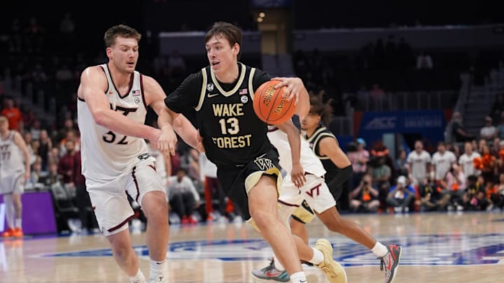 Mar 10, 2026; Charlotte, NC, USA; Wake Forest Demon Deacons forward Cooper Schwieger (13) drives to the basket defended by Virginia Tech Hokies center Christian Gurdak (32) during the second half at Spectrum Center. Mandatory Credit: Jim Dedmon-Imagn Images