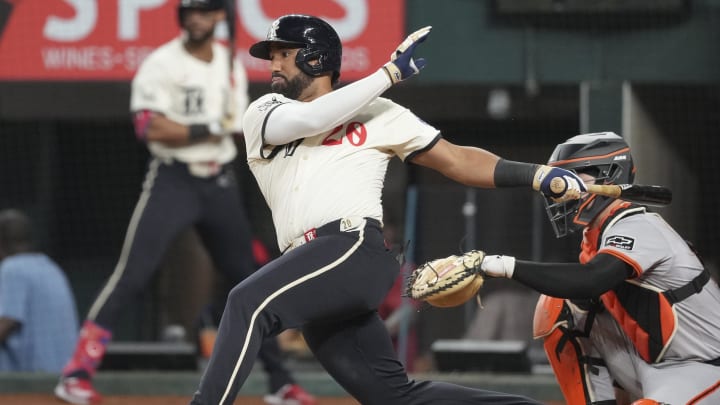 Jun 7, 2024; Arlington, Texas, USA; Texas Rangers third baseman Ezequiel Duran follows through on his RBI single against the San Francisco Giants during the fifth inning at Globe Life Field. 