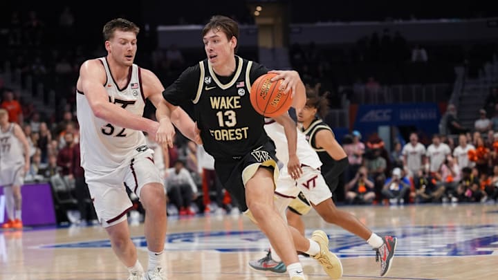 Mar 10, 2026; Charlotte, NC, USA; Wake Forest Demon Deacons forward Cooper Schwieger (13) drives to the basket defended by Virginia Tech Hokies center Christian Gurdak (32) during the second half at Spectrum Center. Mandatory Credit: Jim Dedmon-Imagn Images
