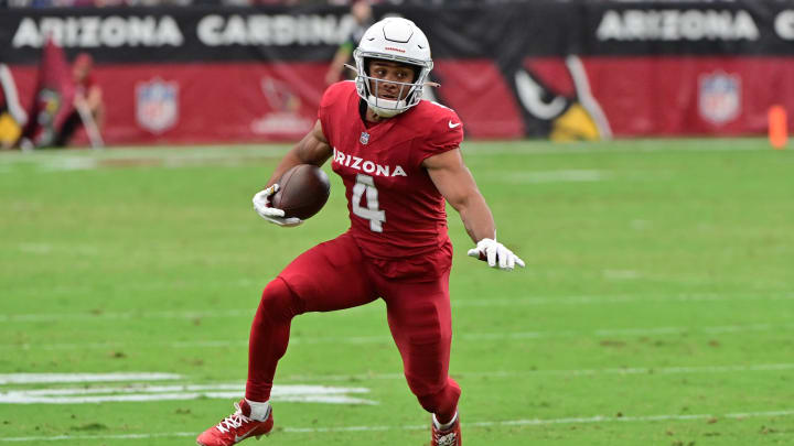 Sep 24, 2023; Glendale, Arizona, USA;  Arizona Cardinals wide receiver Rondale Moore (4) runs the ball in the first half against the Dallas Cowboys at State Farm Stadium. Mandatory Credit: Matt Kartozian-USA TODAY Sports