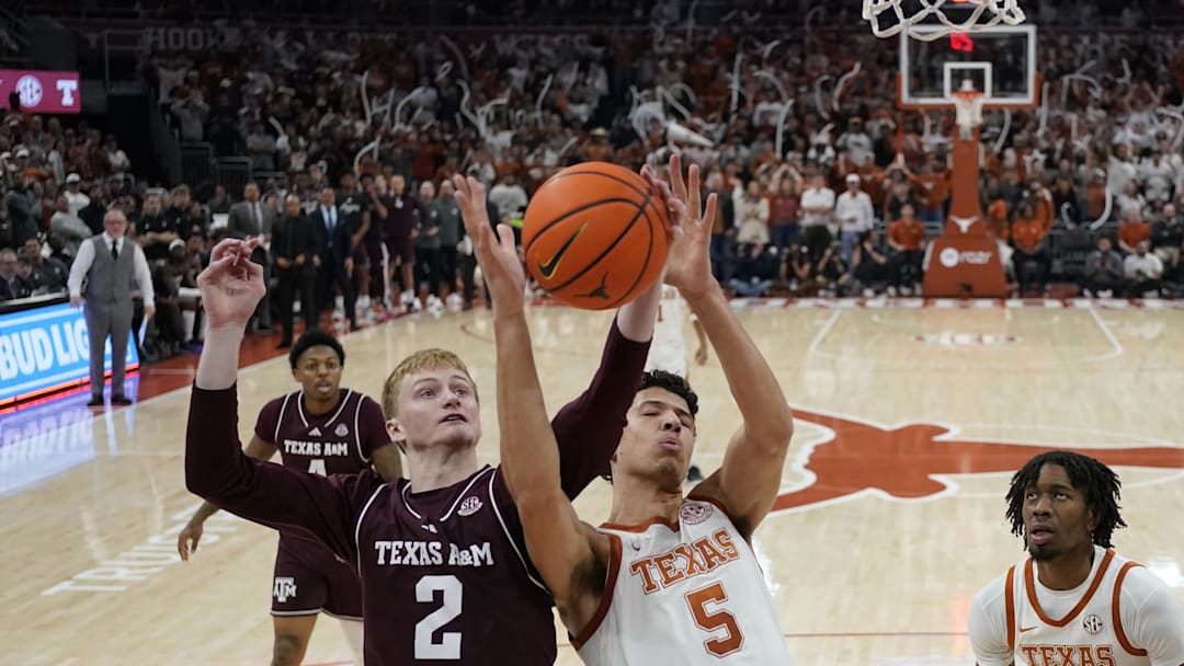 Jan 25, 2025; Austin, Texas, USA; Texas A&M Aggies guard Hayden Hefner (2) and Texas Longhorns forward Kadin Shedrick (5) battle for a rebound during the second half at Moody Center. Mandatory Credit: Scott Wachter-Imagn Images