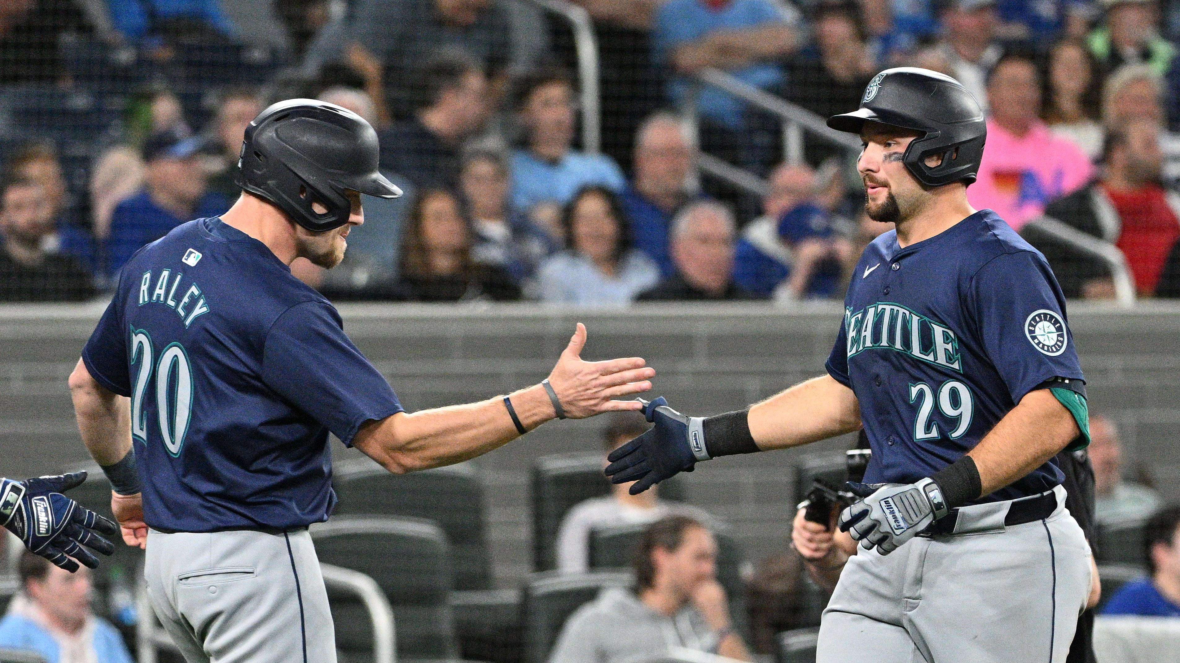 Apr 10, 2024; Toronto, Ontario, CAN;   Seattle Mariners catcher Cal Raleigh (29) is greeted by Luke Raley (20).