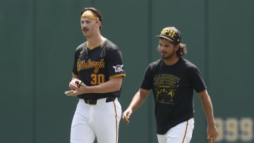 May 26, 2024; Pittsburgh, Pennsylvania, USA;  Pittsburgh Pirates pitchers Paul Skenes (left) and Jared Jones (right) walk in the outfield before the game against the Atlanta Braves at PNC Park. Mandatory Credit: Charles LeClaire-USA TODAY Sports