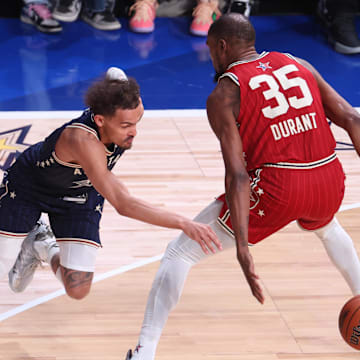 Feb 18, 2024; Indianapolis, Indiana, USA; Eastern Conference guard Trae Young (11) of the Atlanta Hawks dribbles past Western Conference forward Kevin Durant (35) of the Phoenix Suns during the second quarter in the 73rd NBA All Star game at Gainbridge Fieldhouse. Mandatory Credit: Trevor Ruszkowski-Imagn Images