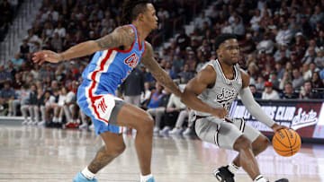 Feb 21, 2024; Starkville, Mississippi, USA; Mississippi State Bulldogs guard Josh Hubbard (13) drives to the basket as Mississippi Rebels guard Allen Flanigan (7) defends during the second half at Humphrey Coliseum. Mandatory Credit: Petre Thomas-Imagn Images