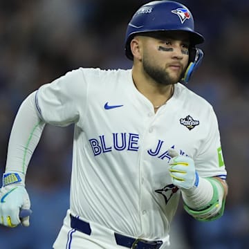 Nov 1, 2025; Toronto, Ontario, CAN; Toronto Blue Jays designated hitter Bo Bichette (11) runs after hitting a three run home run against the Los Angeles Dodgers in the third inning during game seven of the 2025 MLB World Series at Rogers Centre. 