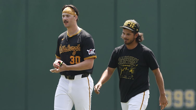 May 26, 2024; Pittsburgh, Pennsylvania, USA;  Pittsburgh Pirates pitchers Paul Skenes (left) and Jared Jones (right) walk in the outfield before the game against the Atlanta Braves at PNC Park. Mandatory Credit: Charles LeClaire-USA TODAY Sports