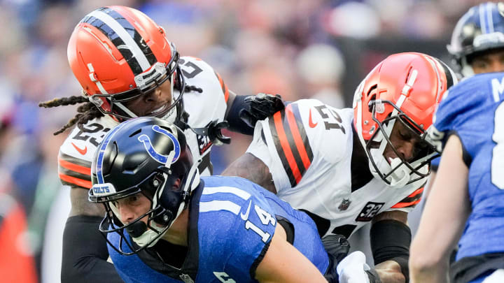 Indianapolis Colts wide receiver Alec Pierce (14) works to evade tackle by Cleveland Browns cornerback Martin Emerson Jr. (23) and Cleveland Browns cornerback Denzel Ward (21) on Sunday, Oct. 22, 2023, during a game against the Cleveland Browns at Lucas Oil Stadium in Indianapolis.