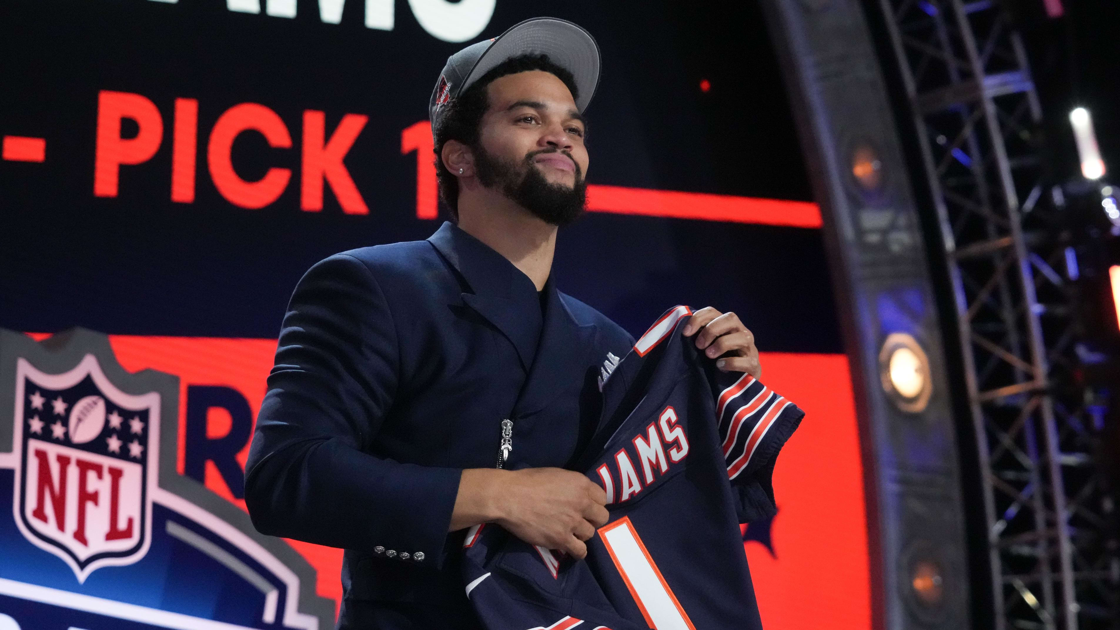 USC quarterback Caleb Williams holds up his new jersey after being picked No. 1 by the Chicago Bears at the NFL draft. 