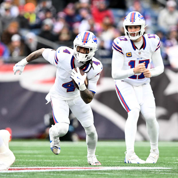 Buffalo Bills quarterback Josh Allen hands off to running back James Cook. Buffalo Bills quarterback Josh Allen hands off to running back James Cook.