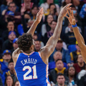 Mar 24, 2023; San Francisco, California, USA;  Philadelphia 76ers center Joel Embiid (21) shoots the basketball over Golden State Warriors forward Draymond Green (23) during the fourth quarter at Chase Center. Mandatory Credit: Neville E. Guard-USA TODAY Sports