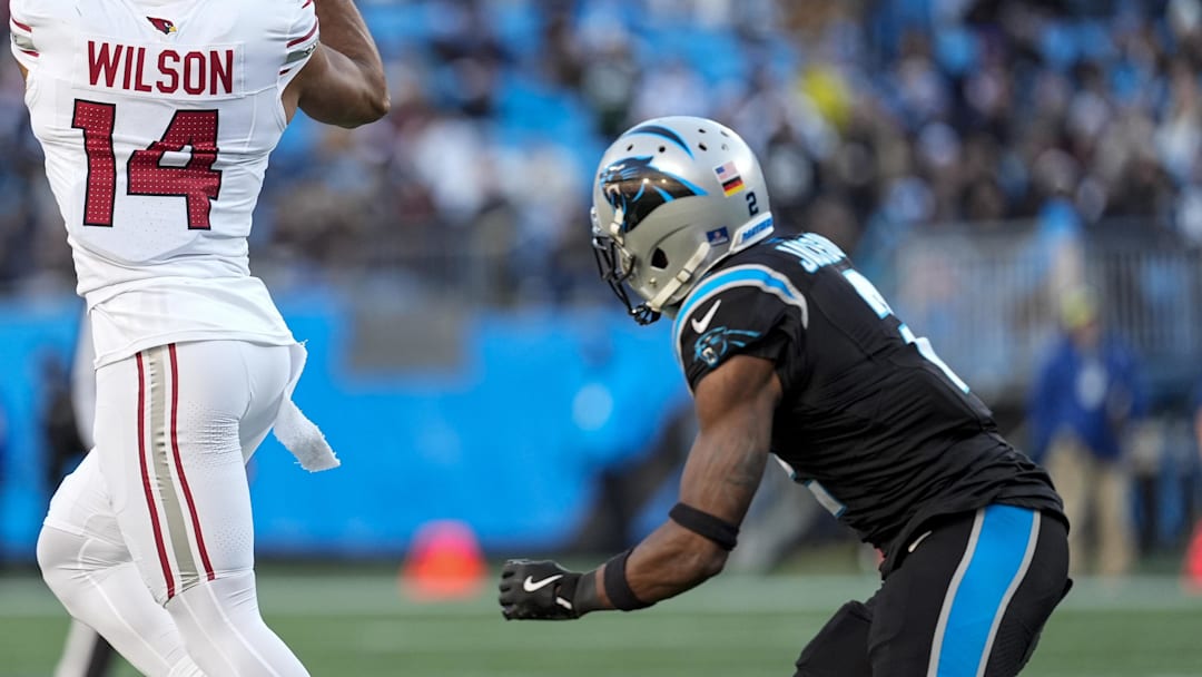 Dec 22, 2024; Charlotte, North Carolina, USA; Arizona Cardinals wide receiver Michael Wilson (14) jumps for a reception defended by Carolina Panthers cornerback Dane Jackson (23) during the second half at Bank of America Stadium. Mandatory Credit: Jim Dedmon-Imagn Images
